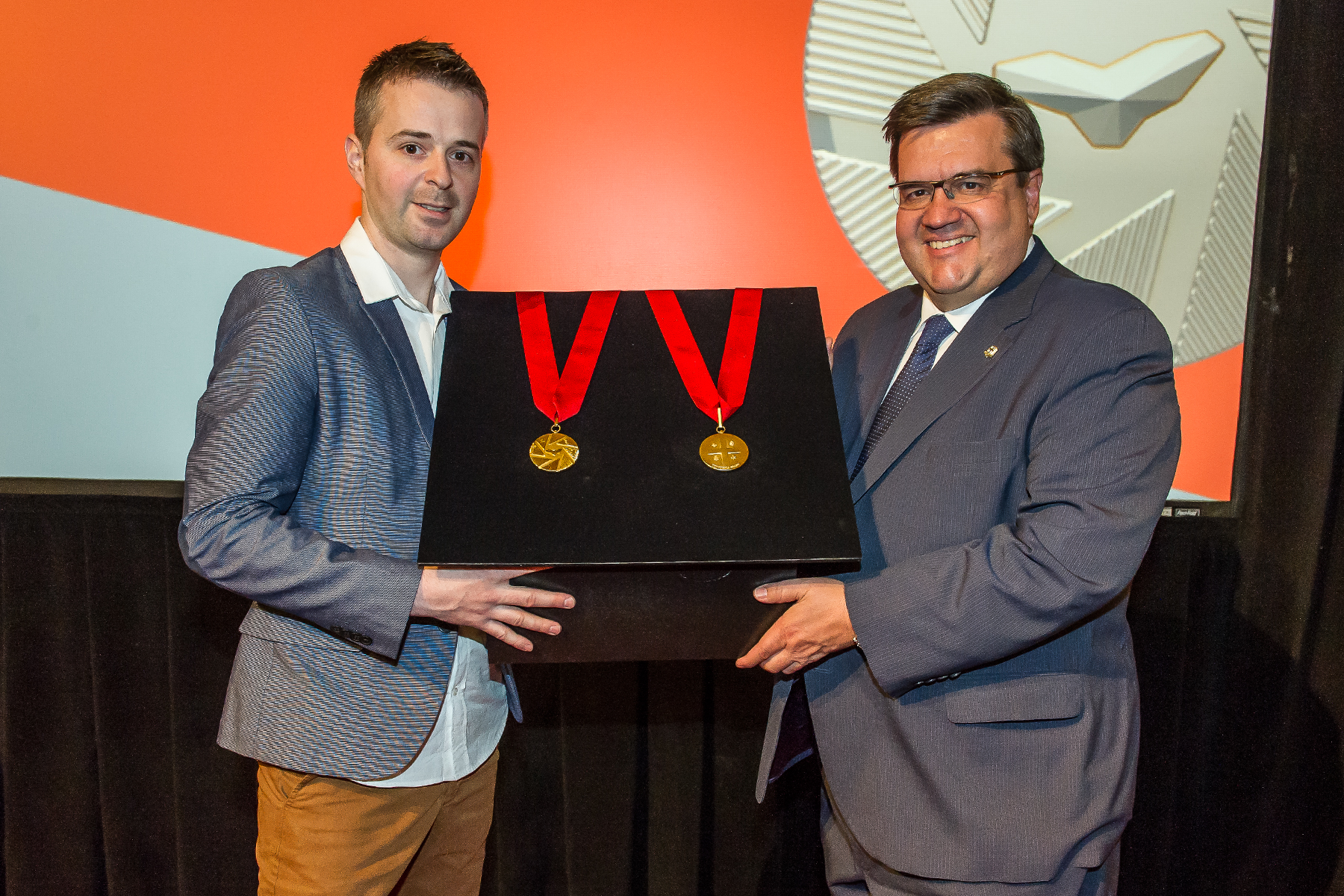 Mayor of Montreal Denis Coderre and Industrial designer Jacques Desbiens unveiling the Ordre de Montréal medal at City Hall on May 27, 2016