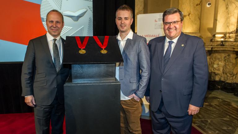 President of the Chamber of commerce Michel Leblanc, Industrial designer Jacques Desbiens and Mayor of Montreal Denis Coderre unveiling the Ordre de Montréal medal, at City Hall, on May 17, 2016